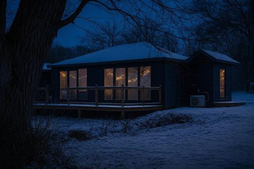 a cabin in the snow at night at 2-bedroom Lake Front Cottage in Harwood ON #2 in Harwood