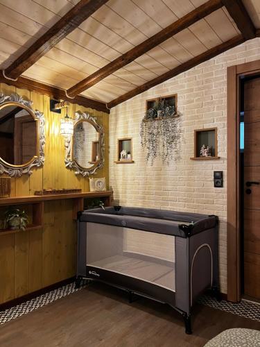 a bathroom with a tub in a room with mirrors at Scandinavian Rustic in Tríkala