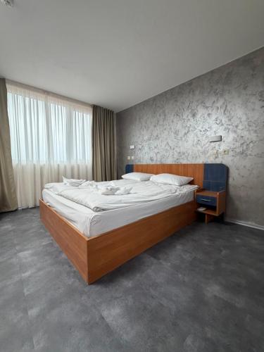 a bedroom with a large bed in a room at Brani Family Hotel in Ruse