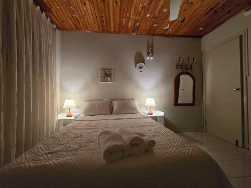 a bedroom with a bed with a towel on it at Esquina Mburucuya in Asunción