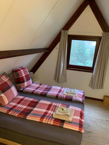 a bedroom with two beds in a attic at La Casita E41 in Lanaken