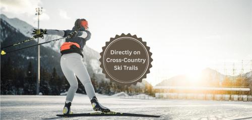 a person on skis in the snow with a sign at Hotel Antholzerhof in Anterselva di Mezzo