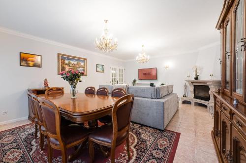 a dining room with a table and a couch at GuestReady - Urban rustic in Esposende in Esposende