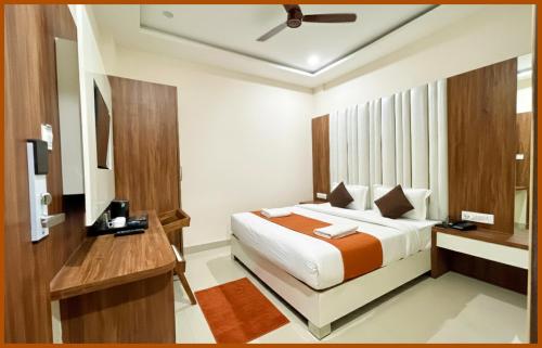 a hotel room with a bed and a desk at Hotel Shri RK Residency Near Kashi Vishwanath Temple - Fully Air Conditioning Rooms - Restaurant-Lift and Free Wifi Facilities- Top Rated Hotel In Varanasi in Kashi