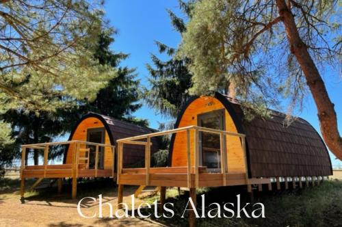 an orange and black cabin with a black roof at Domaine de la Butte Ronde in La Boissière-École