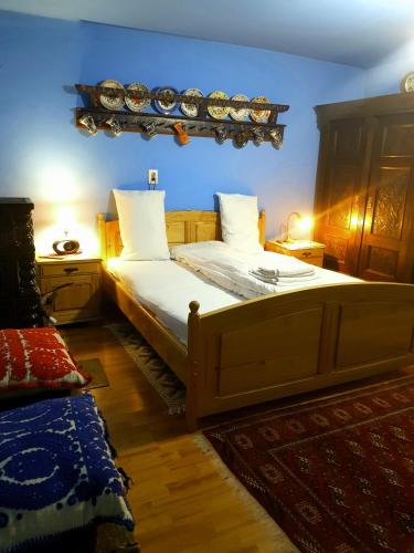 a bedroom with a large bed with white pillows at Casa La Casiru 17 nature in Straja