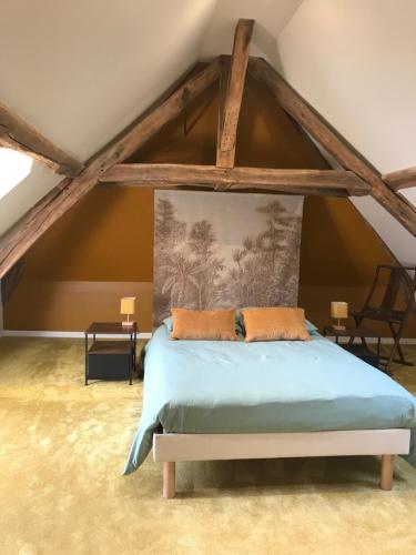 a bedroom with a bed in an attic at Clos des Minimes in Blois