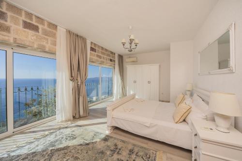 a bedroom with a bed and a large window at Olive Resort in Petrovac na Moru