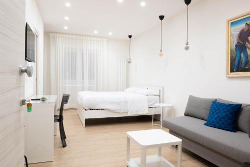 a living room with a bed and a couch at Happy Boutique Home Ercolano in Ercolano