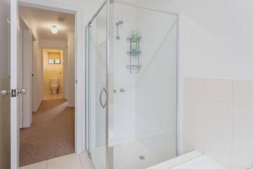 a shower with a glass door in a bathroom at Saltwater Shack in Anglesea