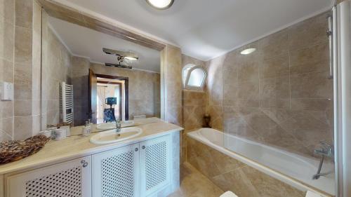 a bathroom with a sink and a tub at Villa Ambiance in Kyrenia