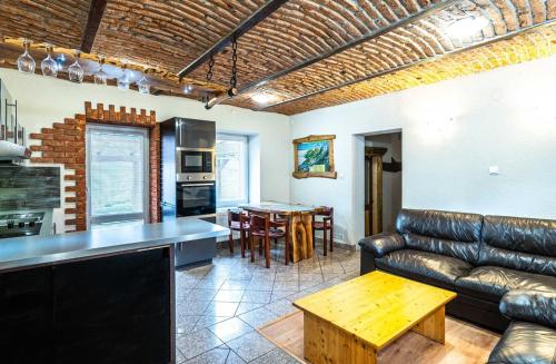 a living room with a couch and a table at Apartman Kamzik - 2 in Veľká Lomnica