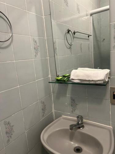 a bathroom with a sink and a mirror at Pousada Marques in Paraty