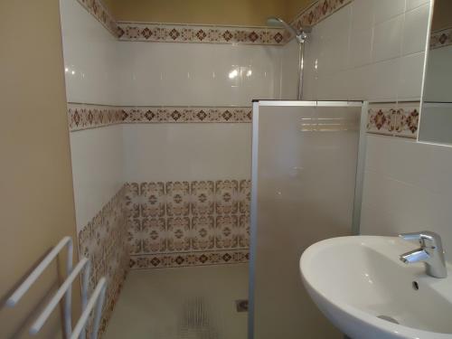a bathroom with a sink and a shower at Chambre d'Hotes La Roseraie in Parsac