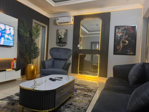 a living room with a couch and a chair at Max Court in Ikeja