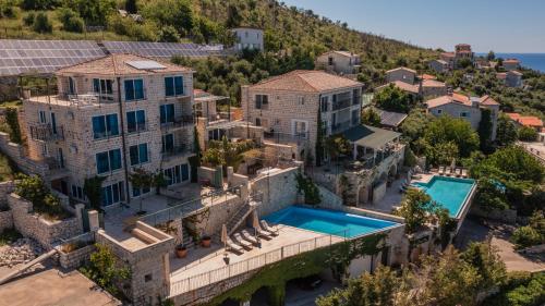 an aerial view of a mansion with a swimming pool at Olive Resort in Petrovac na Moru