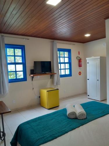 a bedroom with a large bed with two pillows at Recanto dos Açores in Florianópolis