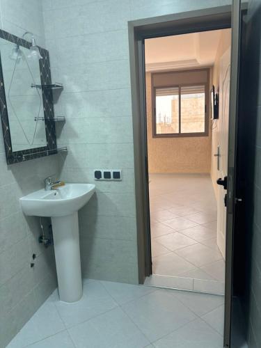 a bathroom with a sink and a mirror at Ber appartement in Mirleft