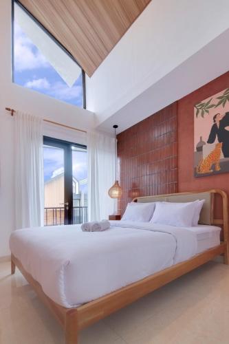 a bedroom with a large bed and a large window at Trevista With Private Pool in Curug 1