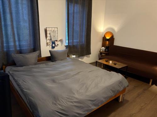 a bedroom with a large bed and a table at Junges Wohnen zwei in Weikersheim