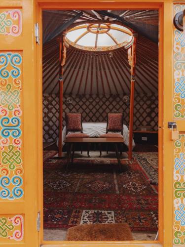 a room with two chairs in a yurt at Glamping yurt at Sequoia Highland Camp in Miramonte