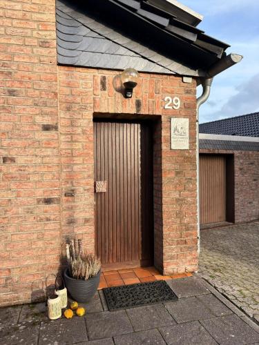 a brick building with a door with a number twenty at Haus Porsche in Hellenthal