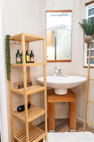 a bathroom with a sink and a mirror at Cozy studio, beach and pool access with sea view in Marigot