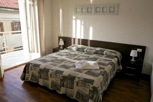 a bedroom with a bed with a quilt on it at Residence Le Terrazze in Trieste