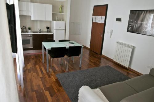 a kitchen and living room with a table and chairs at Residence Le Terrazze in Trieste
