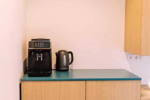 a coffee maker on a counter in a kitchen at The Amsterdam Houseboat Family - de Jordaan Brand New Houseboat! in Amsterdam