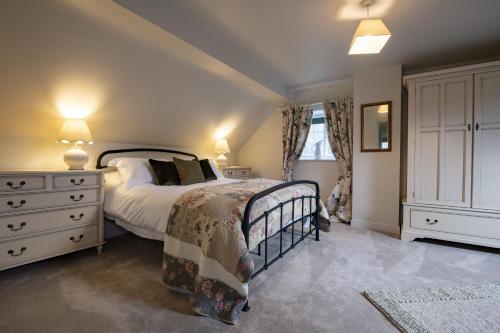 a bedroom with a large bed and a dresser at Lark Rise in Boltby