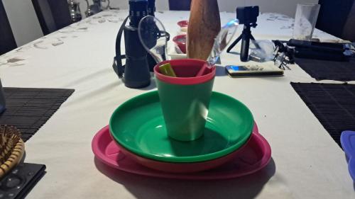 a green cup sitting on a plate on a table at Reserva del Mar Resort Club de Playa in Santa Marta