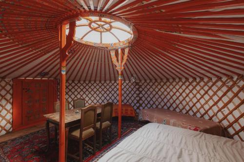 a room with a bed and a table in a yurt at Glamping yurt at a nature retreat Sequoia Highland in Miramonte