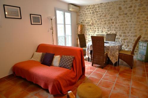 a living room with a couch and a table at Les Mourguettes in La Celle-sous-Gouzon