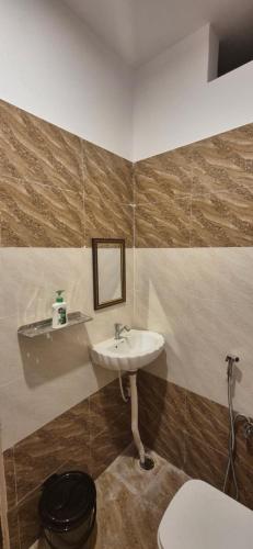 a bathroom with a sink and a toilet at Hotel Shyam Villa in Ayodhya
