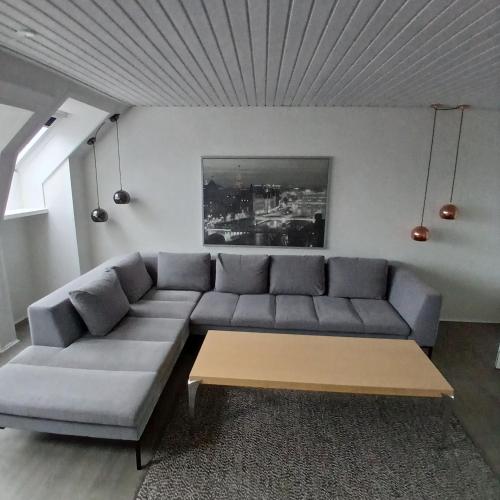 a living room with a couch and a coffee table at Eksklusiv stort boende Suite 1 in Frederikshavn