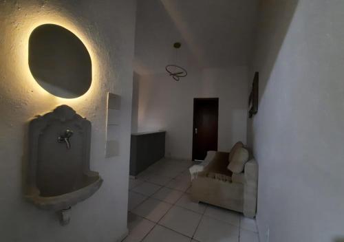 a bathroom with a urinal on the wall and a couch at Pousada Villa in Piquete