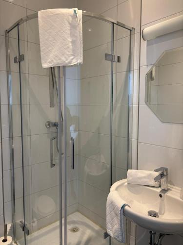 a bathroom with a shower and a sink at Franken Motel in Fürth