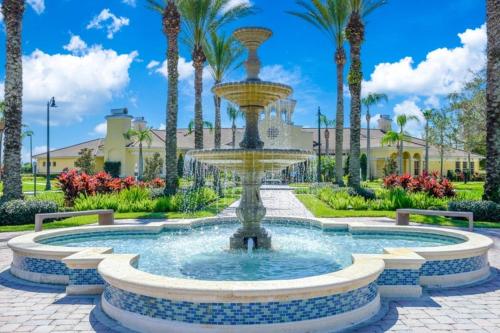 a fountain in a park with palm trees at Vista Cay Jewel Luxury By Universal Orlando Rental in Orlando