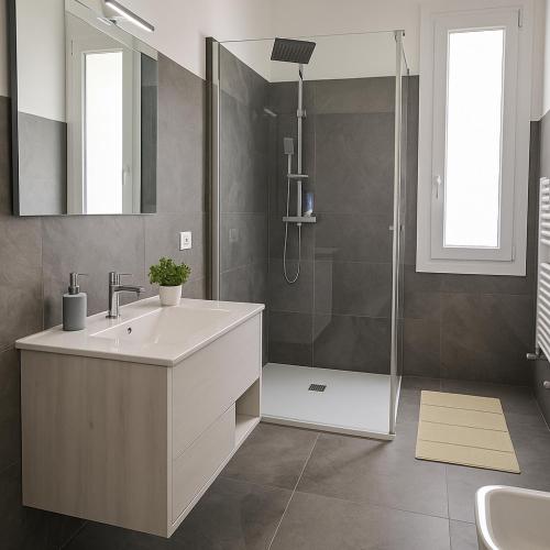 a bathroom with a sink and a shower at Il Giardino di Lilly with private parking garden and air conditioning in Porlezza