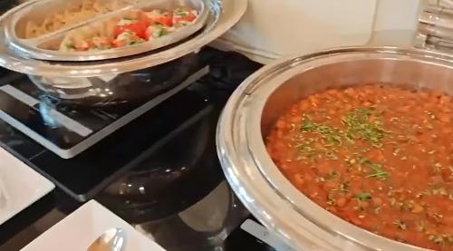 a pot of soup sitting on top of a stove at Luxe Avenue Hotel in Dubai