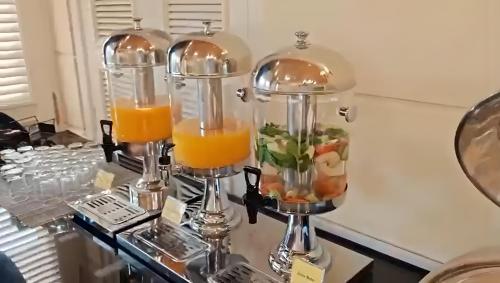 a table topped with two glasses of orange juice at Luxe Avenue Hotel in Dubai