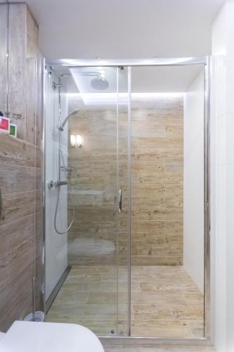 a shower with a glass door in a bathroom at Aparthotel Best Views in Krakow