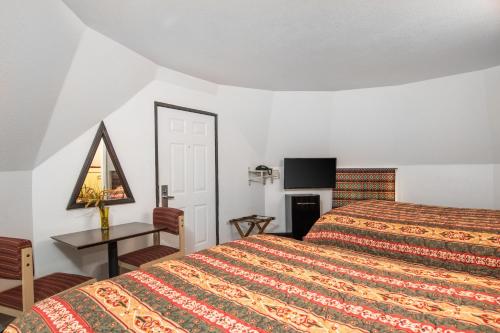 Ένα ή περισσότερα κρεβάτια σε δωμάτιο στο Wigwam Motel