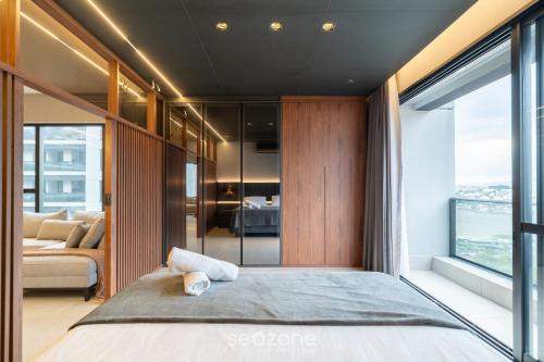 a bedroom with a large bed with a large window at TVT - Luxury studios in the center of Florianópolis in Florianópolis