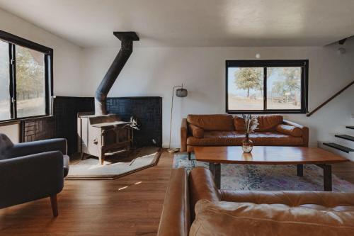 a living room with a couch and a fireplace at Spacious 4-bedroom cabin on secluded private land in Miramonte