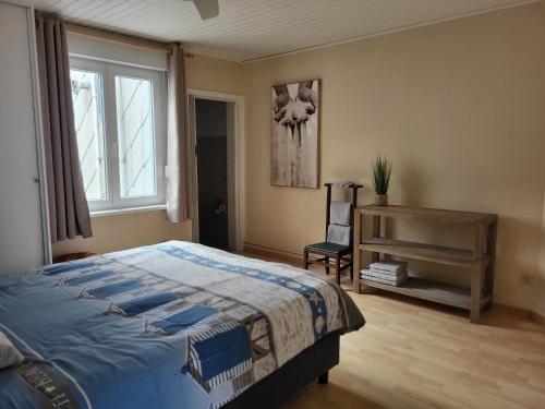 Bonair Gezellig appartement in hartje Wenduine في فينداوني: غرفة نوم بها سرير ومكتب ونافذة