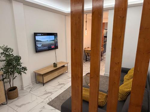 a living room with a tv on a wall at Queluz Maison in Queluz