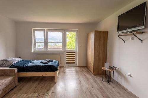 a bedroom with a bed and a flat screen tv at Agroturystyka Na górce in Węgierska Górka