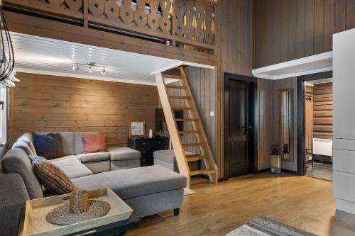 a living room with a couch and a loft bed at Vikinggrenda 16A by Vacation Trysil in Trysil